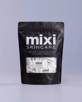 Pack of mixi Skincare premium compressed face cleansing towels on a gray background